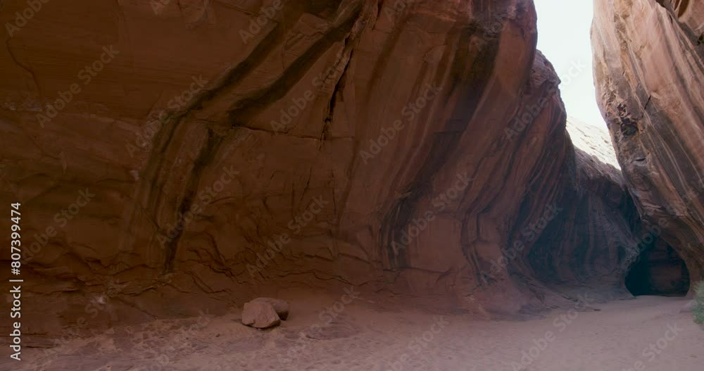 Wide, tilting shot within red, desert rock crevice Wide, tilting shot within red, desert rock crevice