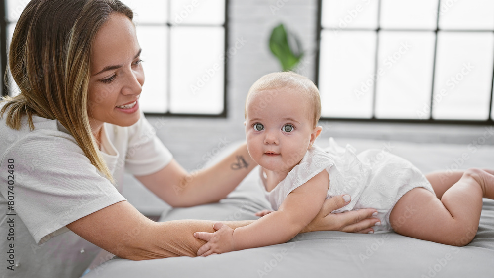 Mother and daughter enjoying a fun, casual play sitting in the bedroom, looking cool and confident, expressing joy, happiness, and a lovely, positive lifestyle indoors. Mother and daughter enjoying a fun, casual play sitting in the bedroom, looking cool and confident, expressing joy, happiness, and a lovely, positive lifestyle indoors.