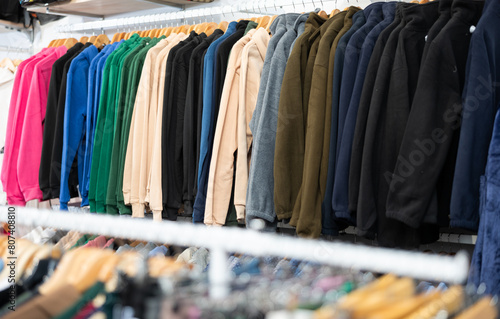Assortment of winter and autumn clothing in modern garment store interior