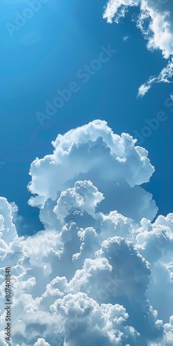 Beautiful cumulus clouds towering in bright blue sky, evoking thoughts of summer days and gentle calm. Copy space.