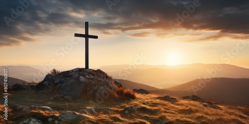 Dramatic sunset over a cross on a hilltop