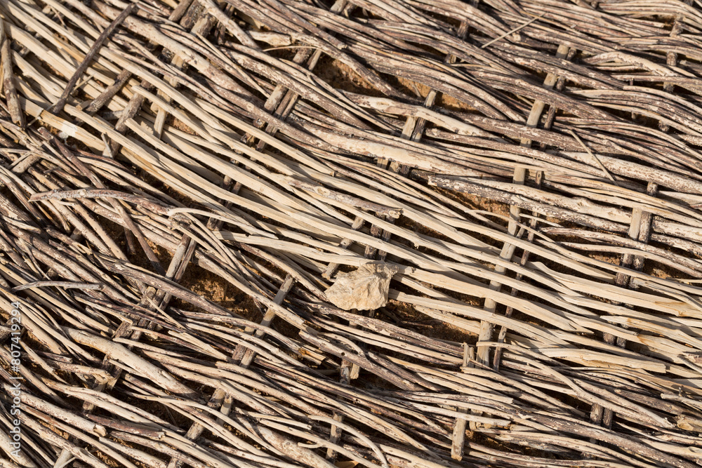 Weaving of twigs of branches. A man-made background smoldering on the ground. Weaving of twigs of branches. A man-made background smoldering on the ground.