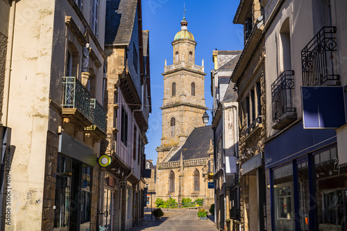 View of the Saint-Gildas church among the buildings in the center of the village. Photography taken in Auray, Brittany, France.