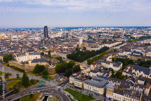 Drone view of ancient Chateau des ducs de Bretagne and Nantes Cathedral on background of downtown with modern skyscraper in summer, France..