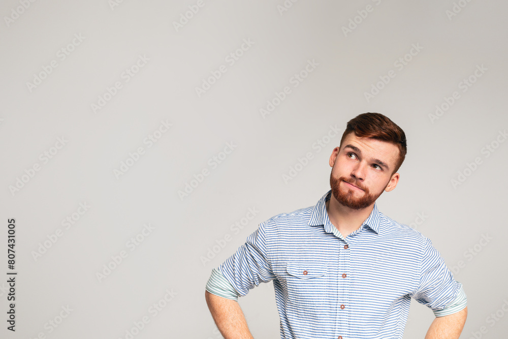 Thoughtful man looking away at copy space on studio background, panorama Thoughtful man looking away at copy space on studio background, panorama