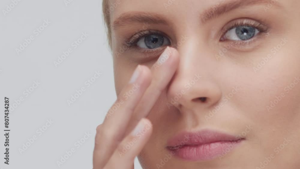 Studio portrait of young, beautiful and natural blond woman applying skin care cream. Face lifting, cosmetics and make-up concept. Studio portrait of young, beautiful and natural blond woman applying skin care cream. Face lifting, cosmetics and make-up concept.