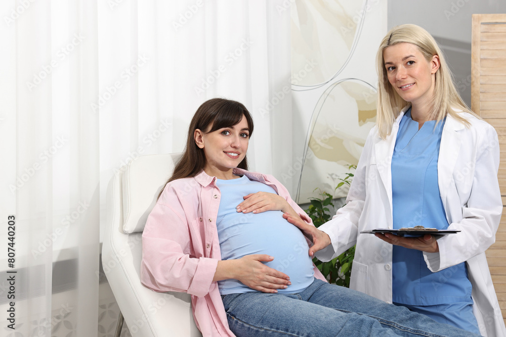 Happy pregnant woman having doctor appointment in hospital Happy pregnant woman having doctor appointment in hospital