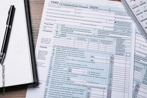 Payroll. Tax return forms, notebook and pen on wooden table, flat lay