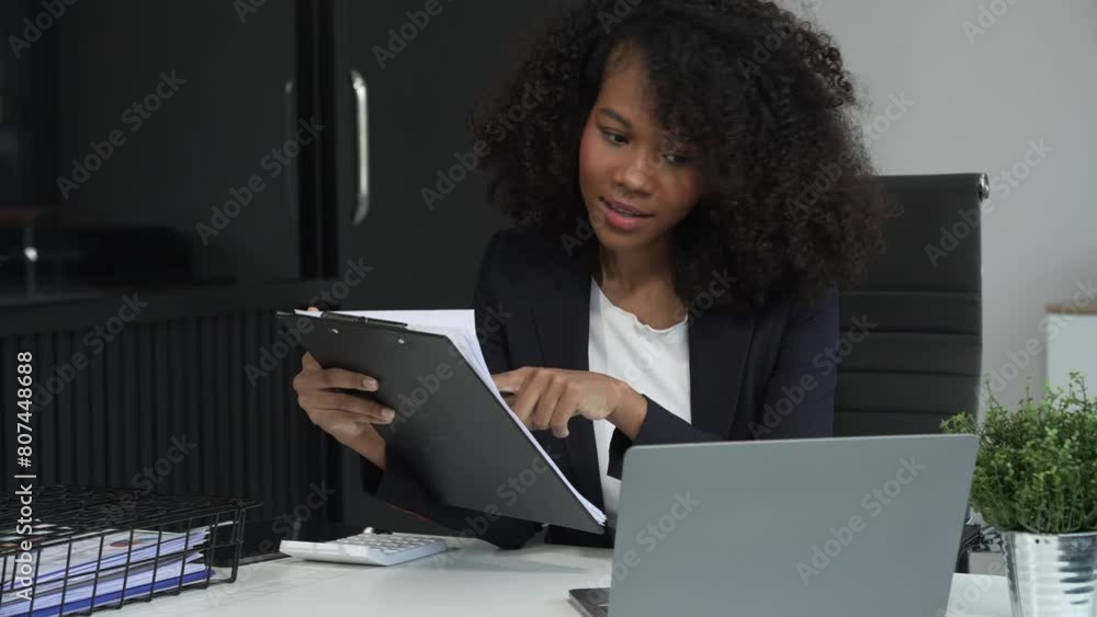 A young African American woman in a blue formal shirt with afro brown hair works as a product designer in a modern office, utilizing skills in design, CAD, CNC, and CNF. A young African American woman in a blue formal shirt with afro brown hair works as a product designer in a modern office, utilizing skills in design, CAD, CNC, and CNF.