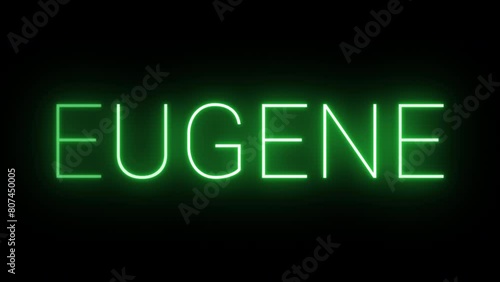 Flickering neon green glowing eugene text animated on black background photo