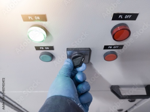 The hand engineer controll of switching on the panel power house in industry, electrical panel conceptual.