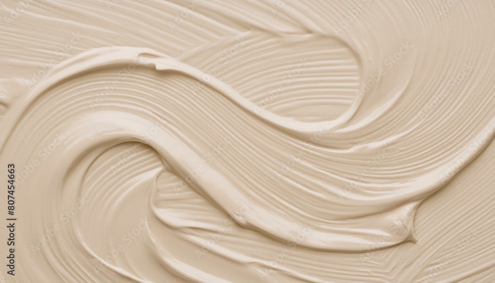 Obraz premium A swirl of a creamy beige substance spread in waves to create a background texture of quiet luxury concept.