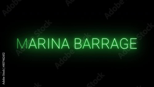 Flickering neon green glowing marina barrage text animated on black background photo