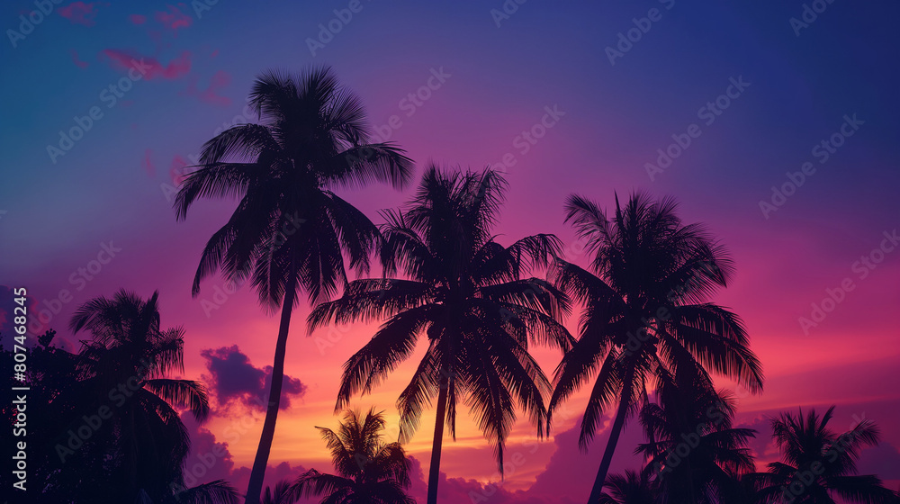 Silhouette of palm trees at sunset