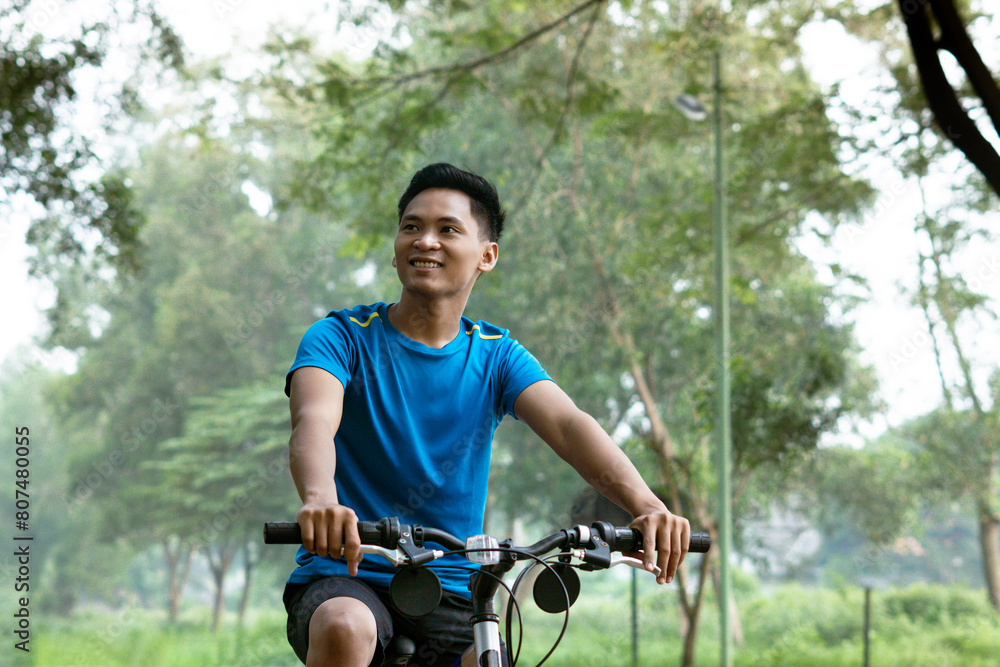 Asian Man Cycling in Blue Sports Shirt for Health and sport Ad.
