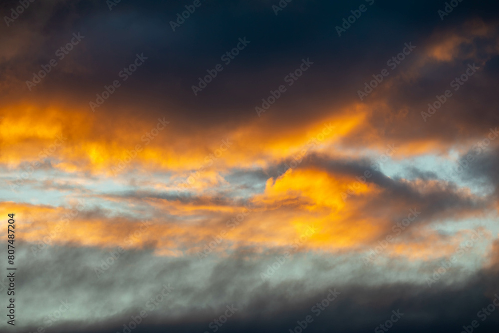 orange colored clouds with blue sky background