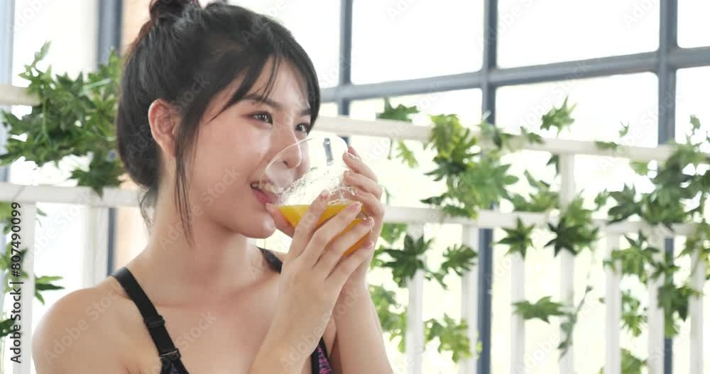 Women hands holding cold orange juice fresh fruit cool drinking. Asian women smile laugh look at camera health care home fitness lifestyle. Beautiful female pouring orange juice from cocktail bottle Women hands holding cold orange juice fresh fruit cool drinking. Asian women smile laugh look at camera health care home fitness lifestyle. Beautiful female pouring orange juice from cocktail bottle