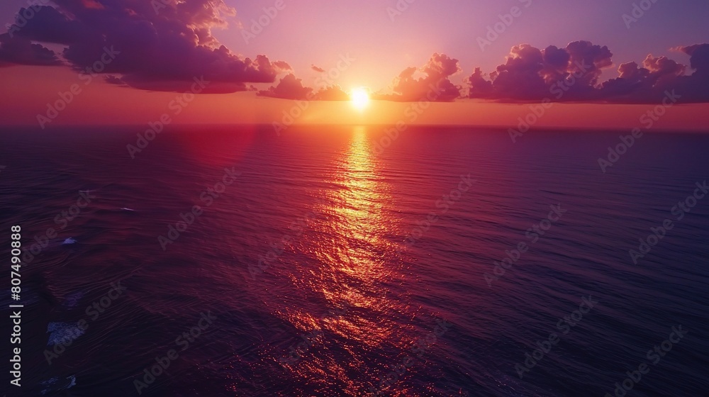 aerial view of the ocean at sunset, with the sky ablaze in shades of orange aerial view of the ocean at sunset, with the sky ablaze in shades of orange