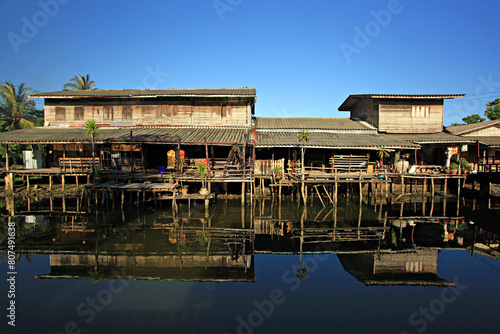 Wooden houses near the water Rural life at Ban Khlong Dan, Songkhla Province, Thailand  © kosin_sukhum