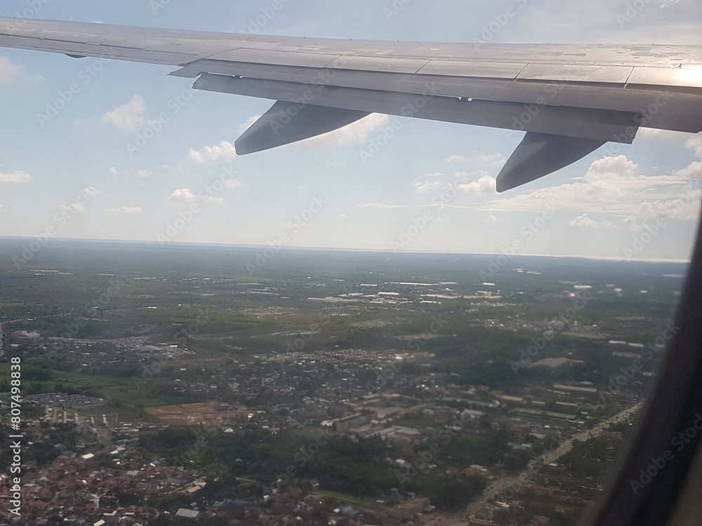 Looking through window aircraft during flight in wing with a nice blue clear sky and beautiful clouds. flying and traveling, view from airplane that can see outside. Looking through window aircraft during flight in wing with a nice blue clear sky and beautiful clouds. flying and traveling, view from airplane that can see outside.