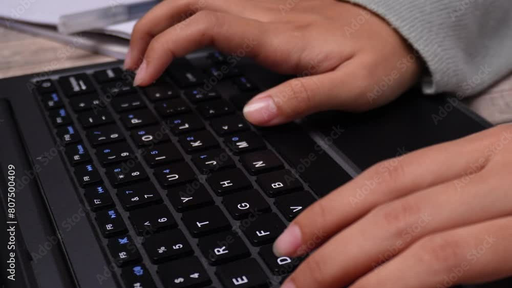 hands on keyboard with book and ruler on wooden table hands on keyboard with book and ruler on wooden table