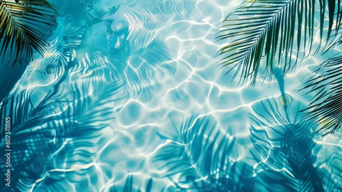 Top view of tropical leaf shadow on pool water surface. Beautiful abstract background concept banner. © Bird Visual