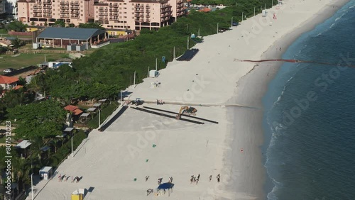 Machinery at work expanding the beach of Jurere in Florianopolis, Brazil. photo