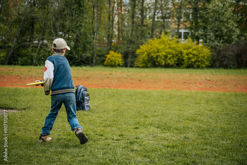 A boy throws disc golf. A young boy learns to throw a discus