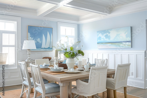 Light blue colored wainscoting in the dining room with a white ceiling and light wood table, neutral chairs, coastal style home