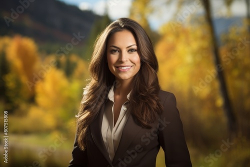 Confident businesswoman smiling in autumn landscape