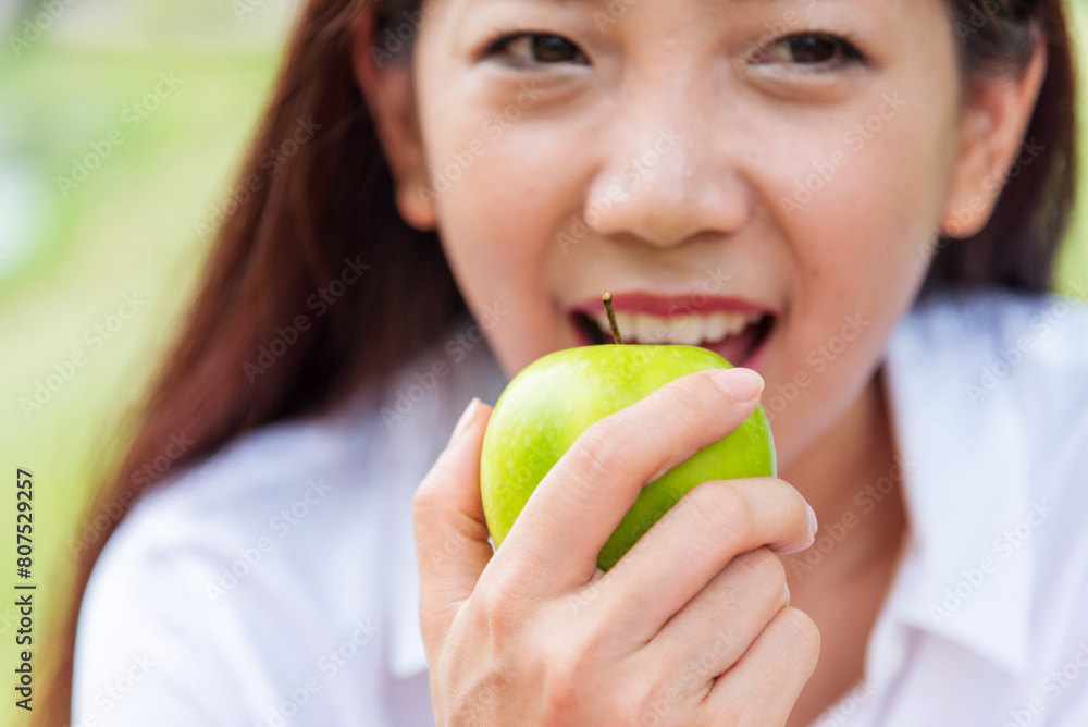young asian woman eating Apple Healthy. Girl workout holding organic apple fruit healthy lifestyle. Wellness Asian women eat red apple smile face look at camera. Beauty health care lifestyle concept young asian woman eating Apple Healthy. Girl workout holding organic apple fruit healthy lifestyle. Wellness Asian women eat red apple smile face look at camera. Beauty health care lifestyle concept