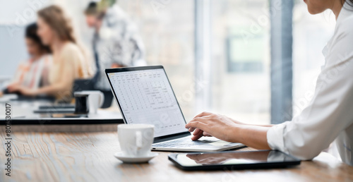 Closeup image of woman hands using and typing on laptop