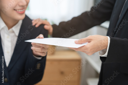Good job Asian manager businesswoman giving financial reward in an envelope, business letter extra salary to company employee, woman worker office hand received premium bonus, getting cheque from boss photo