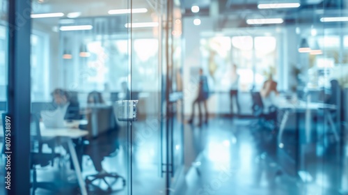 Blurred offices with people working behind glass walls