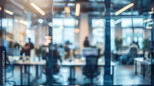 Blurred offices with people working behind glass walls