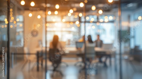 Blurred offices with people working behind glass walls