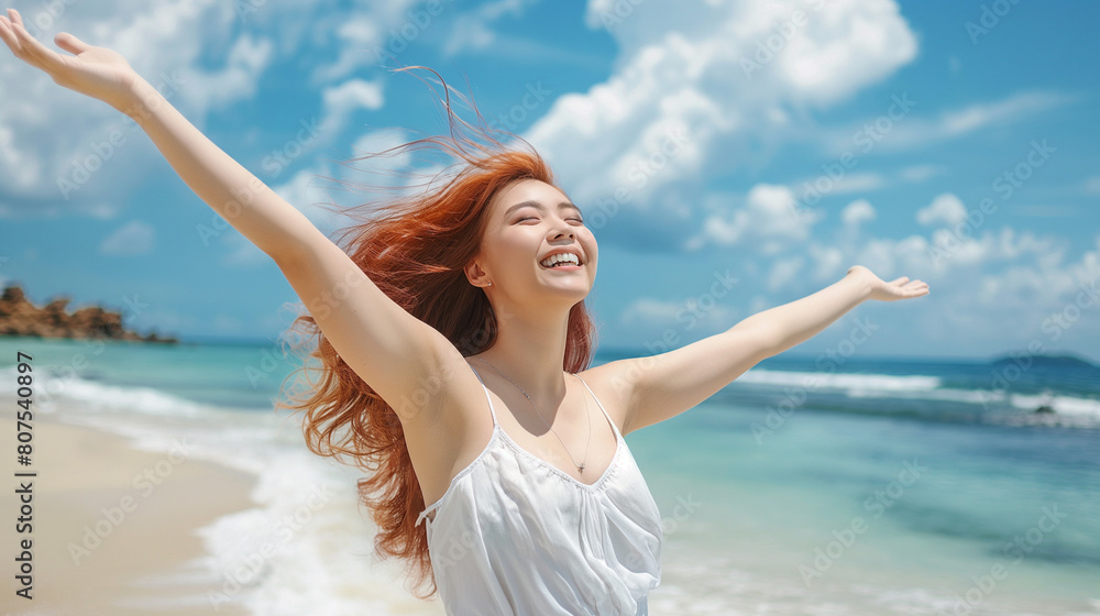 woman with arms outstretched enjoying freedom at the beach woman with arms outstretched enjoying freedom at the beach