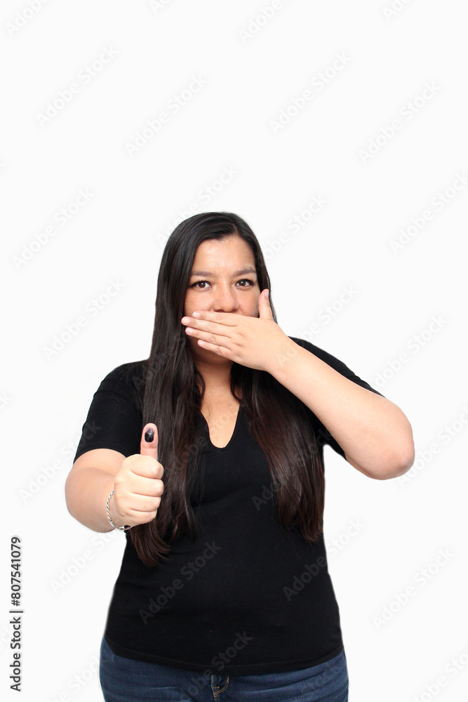 Latin adult woman shows her thumb inked with indelible electoral ink after exercising her right to free and secret voting Latin adult woman shows her thumb inked with indelible electoral ink after exercising her right to free and secret voting