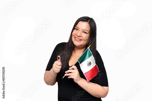 Latin adult woman shows her thumb inked with indelible electoral ink after exercising her right to free and secret voting