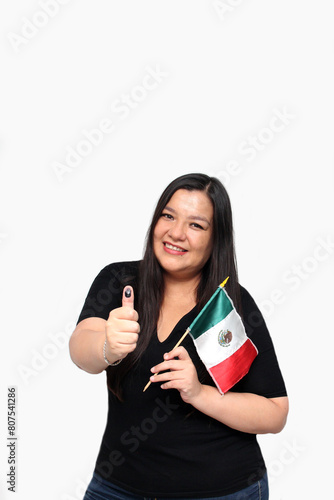 Latin adult woman shows her thumb inked with indelible electoral ink after exercising her right to free and secret voting photo