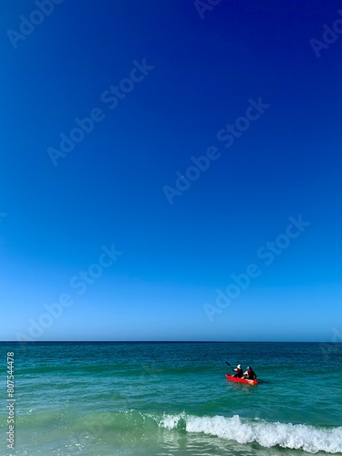 Beach with Sky, Ocean, and Kayakers