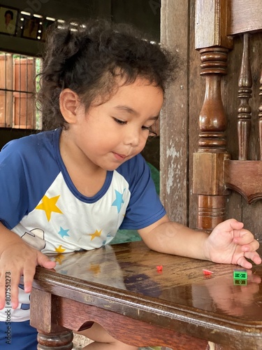 little child playing with toy