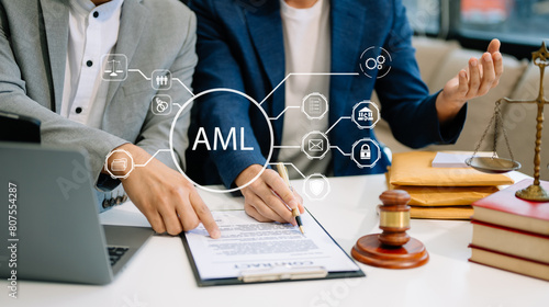 AML Anti Money Laundering Financial Bank Business Concept. judge in a courtroom using laptop and tablet with AML anti money laundering icon photo