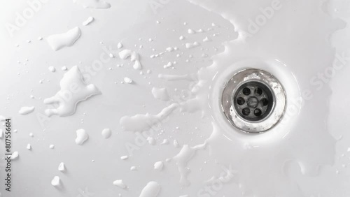 The running water drains on bathtub. Household plumbing. Cleaning and hygiene concept.