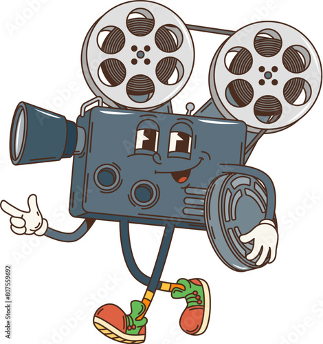 Groovy retro cartoon movie camera funky character with happy face, vector 70s hippie comic. Groovy funny camera with filmstrip of movie cinema theater, smiling retro video camera cartoon character