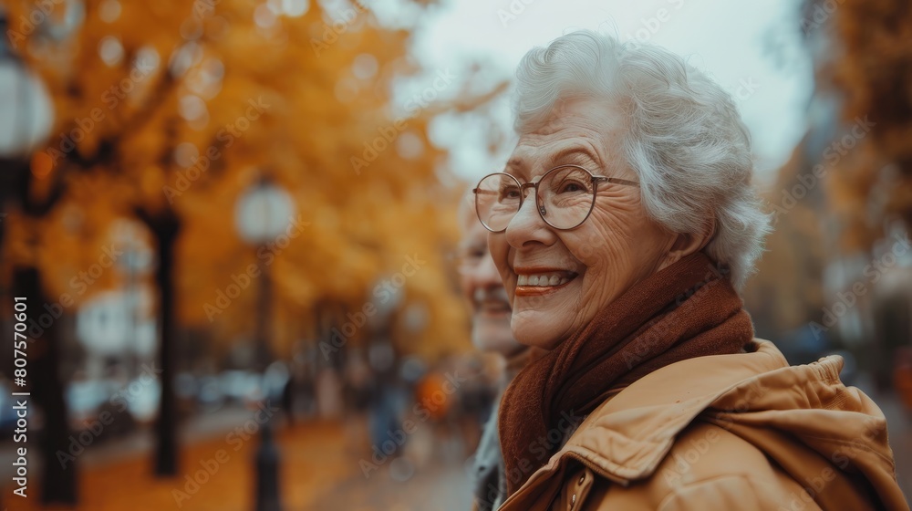 A woman with glasses and a scarf is smiling in front of a tree A woman with glasses and a scarf is smiling in front of a tree