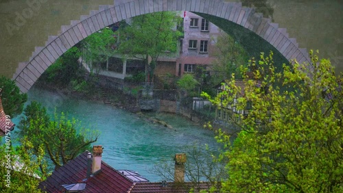 Aare river, slow motion heavy rain under Nydegg bridge, Bern, Switzerland photo