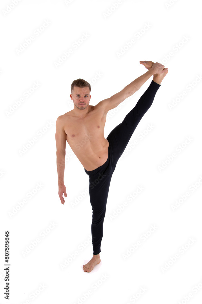 A handsome young man with an athletic body is doing fitness and yoga. White background. A handsome young man with an athletic body is doing fitness and yoga. White background.