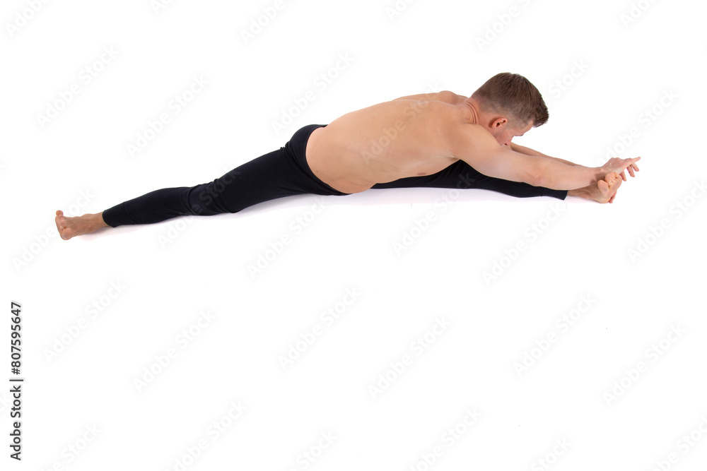 A handsome young man with an athletic body is doing fitness and yoga. White background. A handsome young man with an athletic body is doing fitness and yoga. White background.
