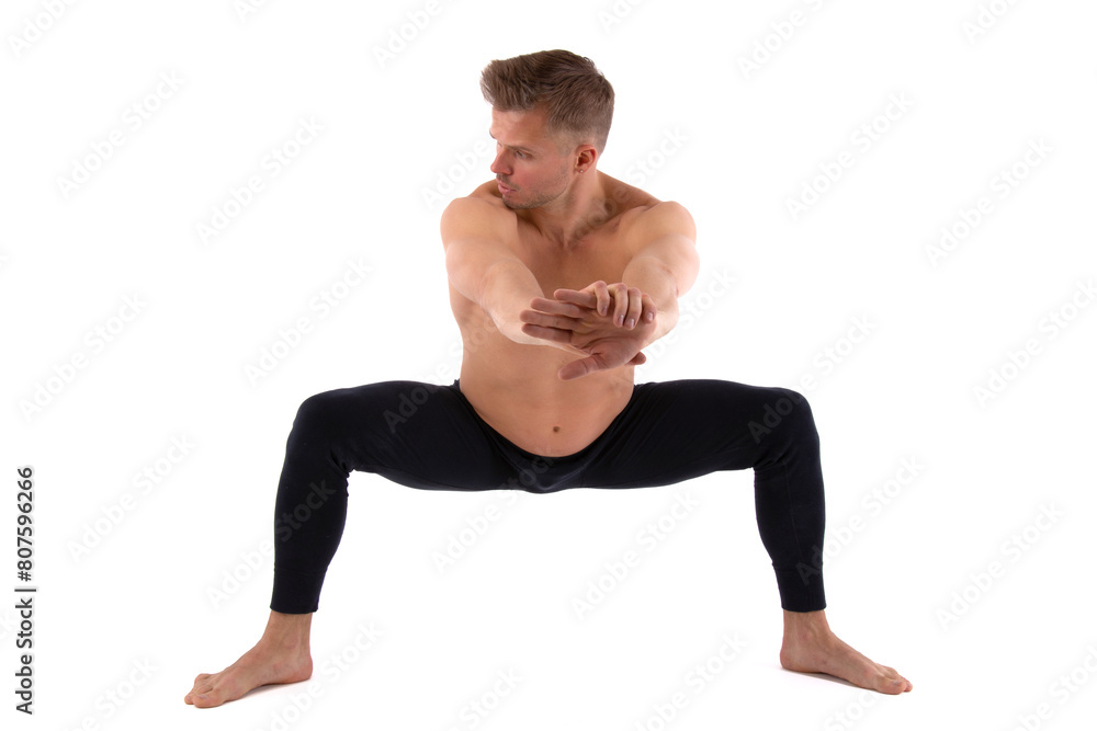 A handsome young man with an athletic body is doing fitness and yoga. White background. A handsome young man with an athletic body is doing fitness and yoga. White background.